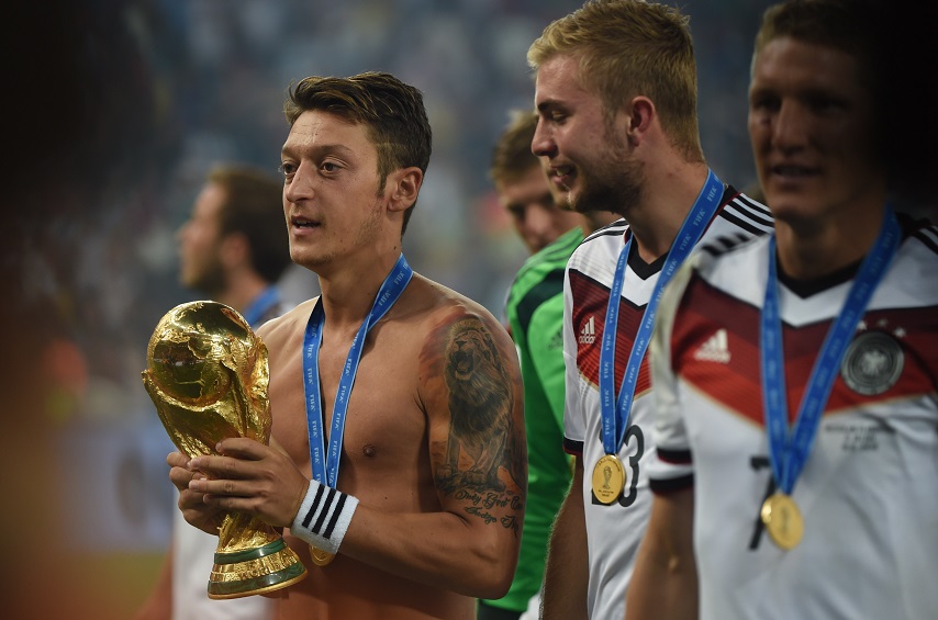 Mesut Ozil of Germany celebrates with the trophy following the