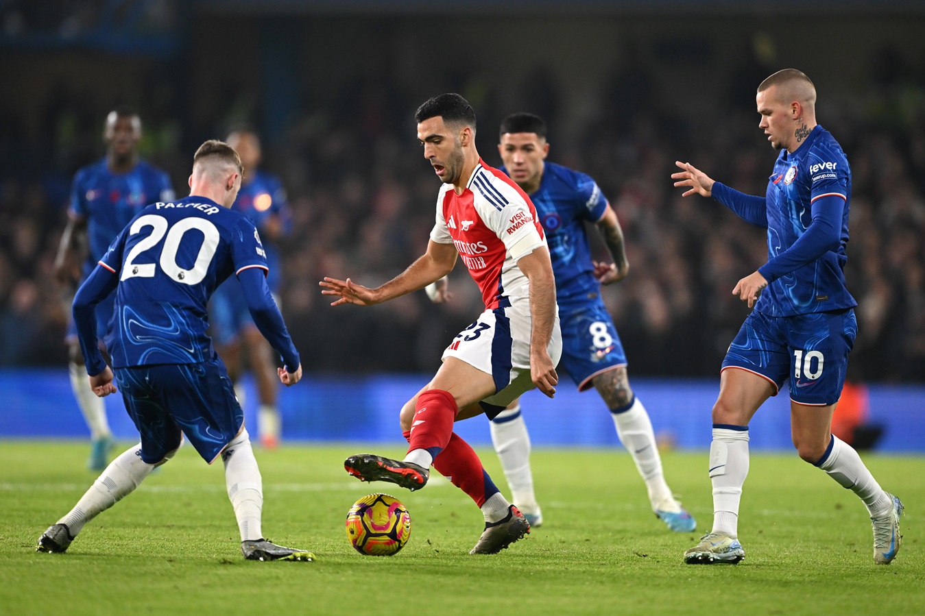 Mikel Merino of Arsenal is surrounded by Cole Palmer, Enzo Fernandez and Mykhaylo Mudryk of Chelsea