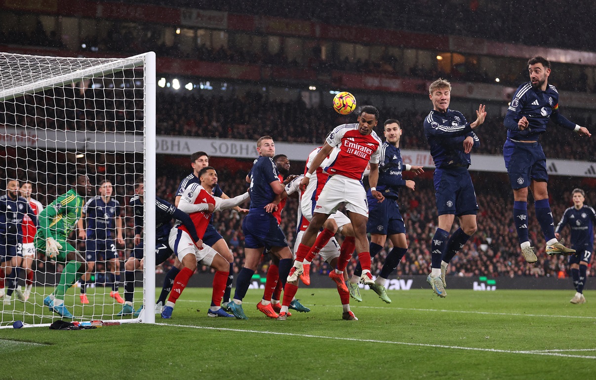 Jurrien Timber of Arsenal scores his team's first goal with a header as Andre Onana of Manchester United fails to make a save during