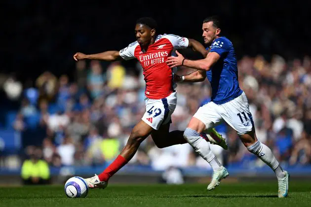 Myles Lewis-Skelly and Jack Harrison compete for the ball.